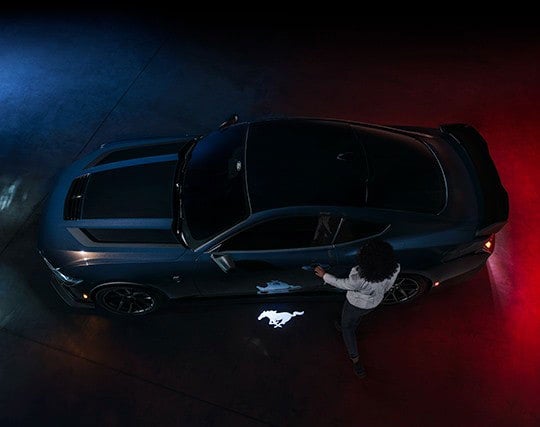 2024 Ford Mustang® Dark Horse™ model with a driver approaching the vehicle | Capital City Ford in Pierre SD