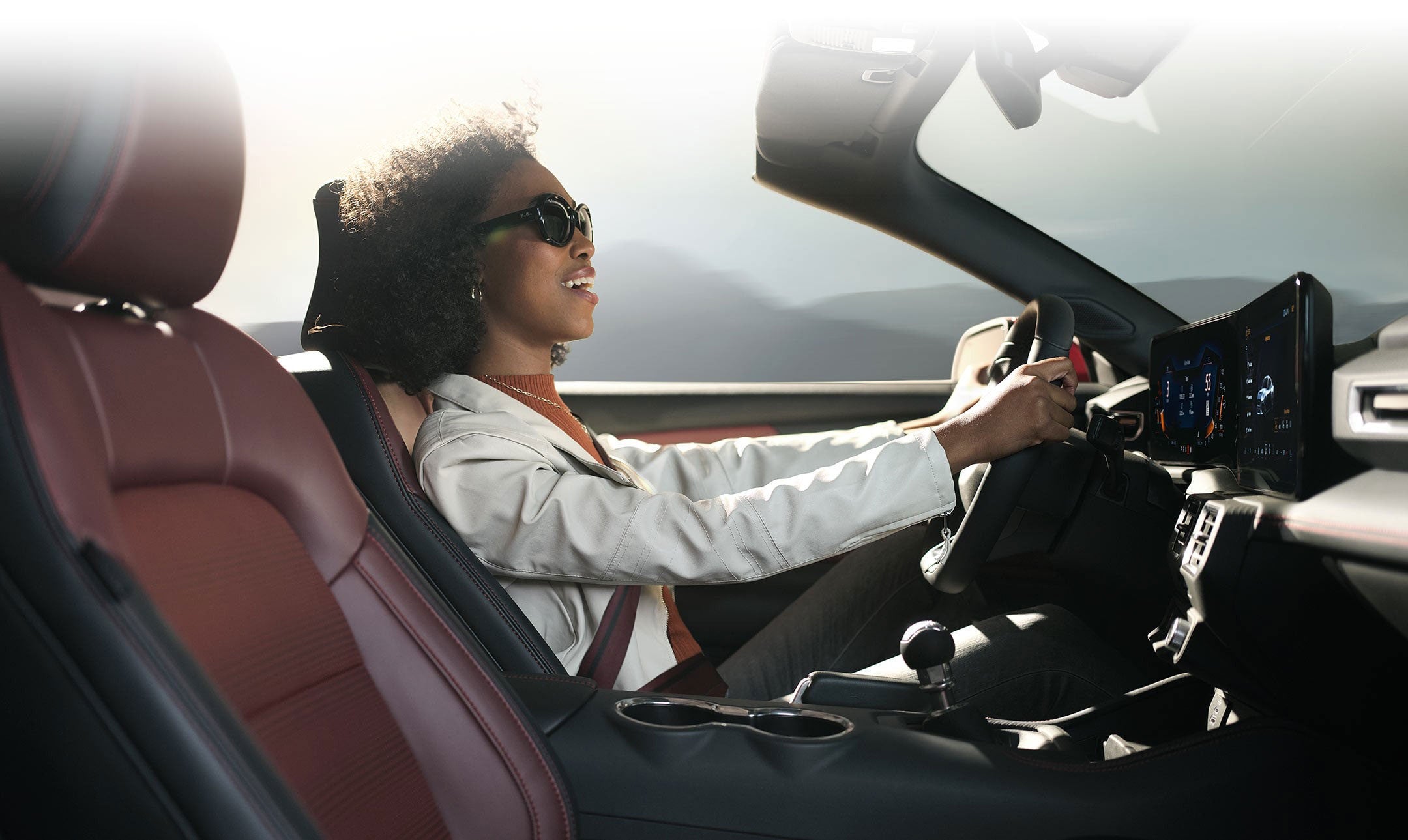 Person sitting in the driver’s seat of a 2024 Ford Mustang® convertible | Capital City Ford in Pierre SD