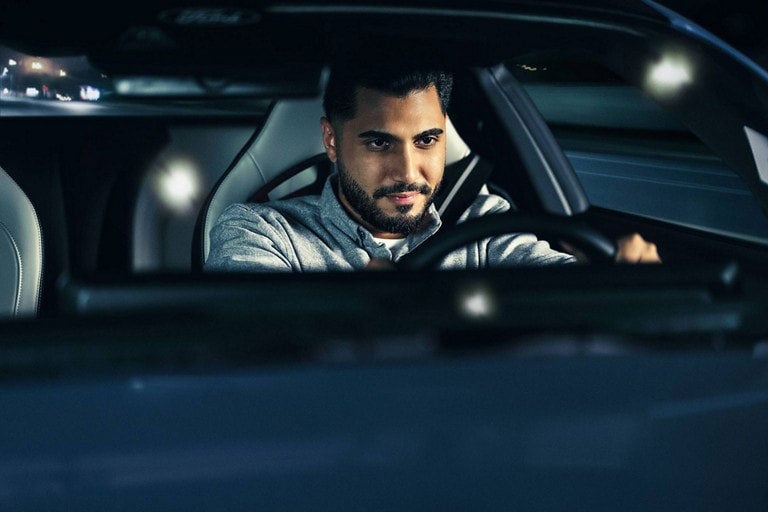 Person sitting in the driver’s seat of a parked 2024 Ford Mustang® coupe | Capital City Ford in Pierre SD